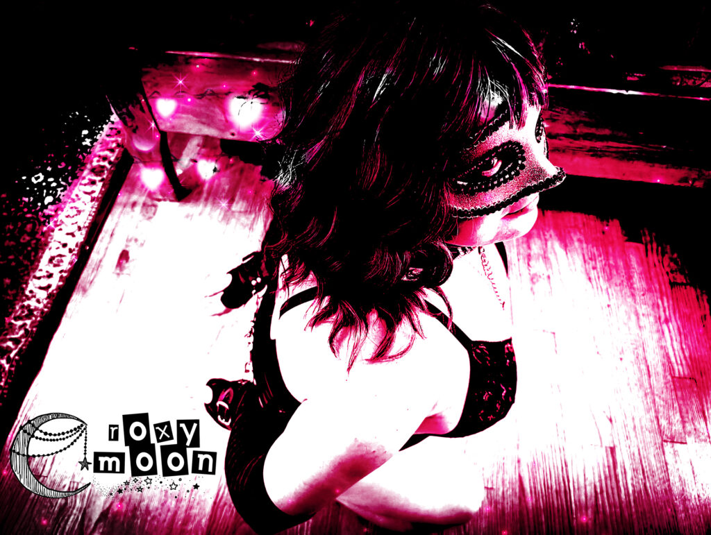 Roxy Moon on the floor with their hands locked up behind their back.